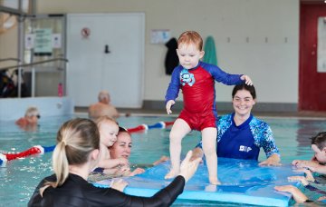 Toddler child balancing on a floating pad